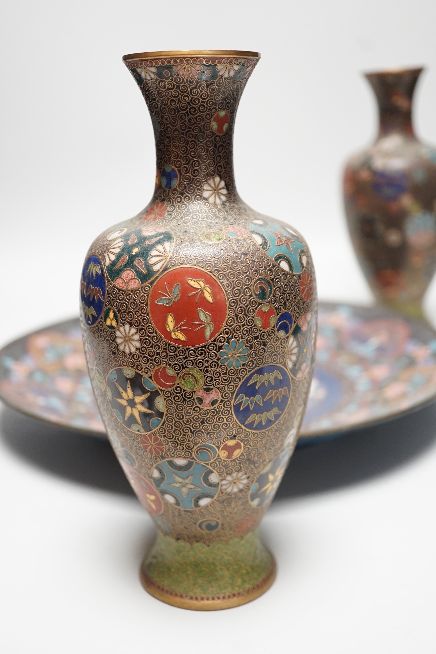 A Japanese cloisonné enamel dish, 30.5cm diameter and a pair of Japanese cloisonné enamel vases. (3)